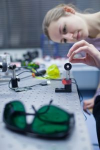 female scientist doing research in a quantum optics lab (color t